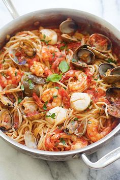 pasta with shrimp, clams and tomato sauce in a pan