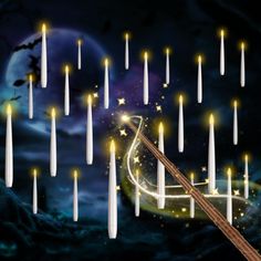 a musical instrument surrounded by candles in front of a night sky with stars and moon