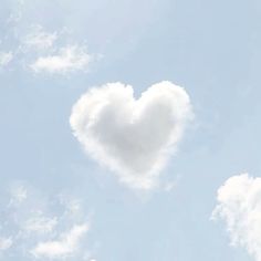 a heart shaped cloud floating in the sky