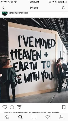 two women standing next to a sign that says i've moved heaven and earth to be with you