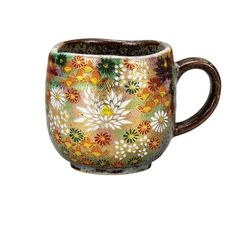 a coffee cup with flowers painted on the outside and inside, sitting in front of a white background