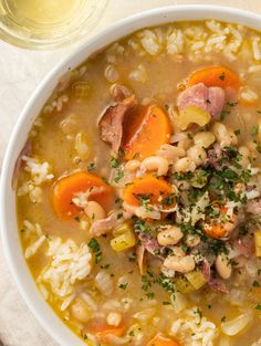 a bowl of soup with rice, ham and carrots