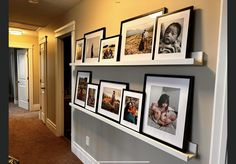 a wall with many pictures hanging on it