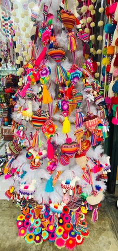 a white christmas tree decorated with colorful ornaments