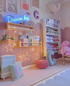 a child's room decorated in pastel pink and blue with lights on the wall