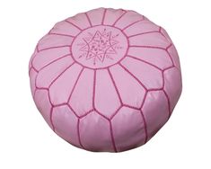 a pink leather poufle with an intricate design on the top and bottom side