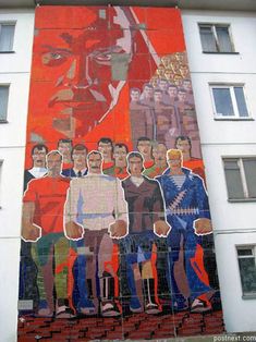 a large mural on the side of a building with men in suits and ties painted on it