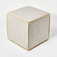 a white cube with gold trim sitting on top of a table