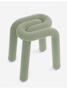 a small stool made out of green fabric with two legs on each side and one foot in the middle