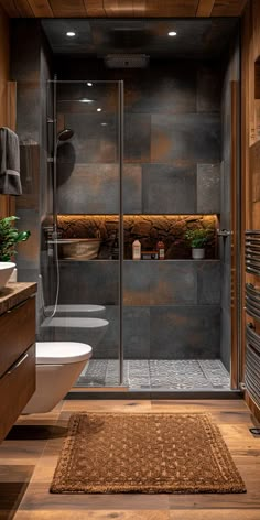 a bathroom with a toilet, sink and shower stall in the middle of the room