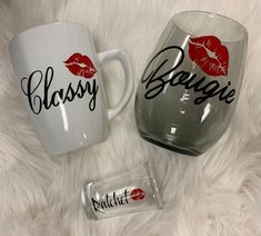 two glass mugs sitting on top of a white fur covered floor