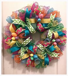 a colorful wreath hanging on the front door