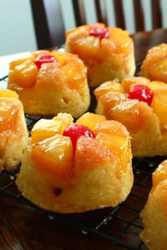 pineapple upside down cakes cooling on a rack