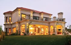 a large house lit up at night in the evening