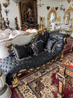 an ornately decorated couch sits in the middle of a room filled with antique furniture