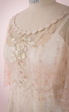 the back of a dress with flowers on it's chest and neckline is shown