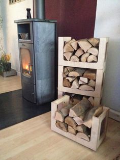 a stack of firewood sitting next to a wood burning stove in a living room