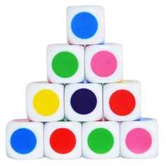 a stack of white dices with different colored dots on each one and the other side