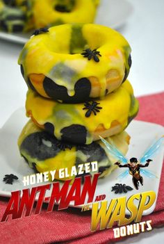 three donuts stacked on top of each other in front of the title for ant - man and the wasp donuts