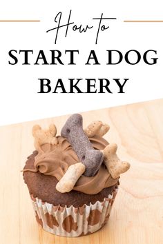 a cupcake with chocolate frosting and dog bone decorations on top, sitting on a wooden table