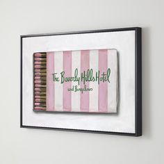 a pink and white striped matchbox with the words the beverly hills hotel on it