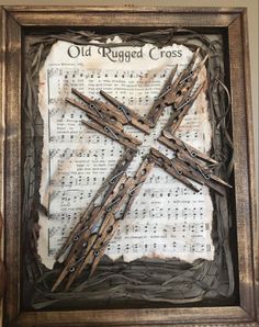 an old rugged cross is displayed in a frame