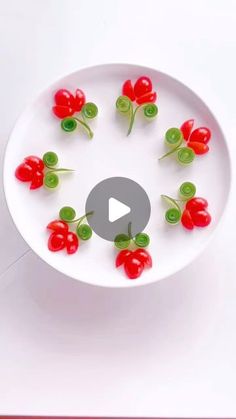 a white bowl filled with red peppers on top of a table