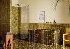 a bathroom with tiled walls and flooring next to a bathtub, shower stall and sink