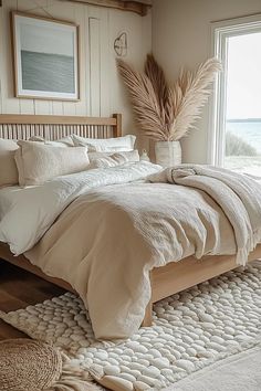 a bedroom with a bed, rug and large window overlooking the ocean is pictured in this image