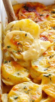 a casserole dish filled with potatoes and cheese