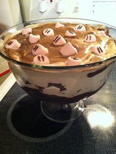 a dessert dish with marshmallows and chocolate in it on top of a counter