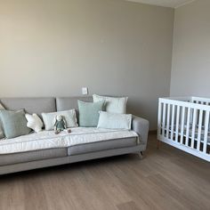 a living room filled with furniture and a baby crib