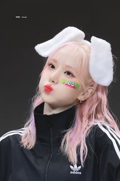 a girl with pink hair and bunny ears on her head wearing a black adidas jacket