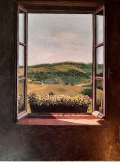 an open window with a view of the countryside