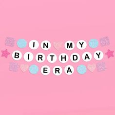 the words in my birthday era are spelled with confetti hearts and stars on a pink background