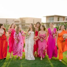 a group of women standing next to each other in dresses