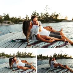 a man and woman sitting on a dock next to the water with their arms around each other