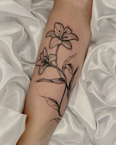 a black and white flower tattoo on the leg