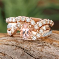 two wedding rings with an oval morganite surrounded by white and rose gold diamond accents