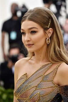 a close up of a person wearing a dress and hair clip in front of a camera