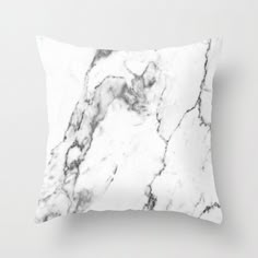 a white and black marble pillow on a wall