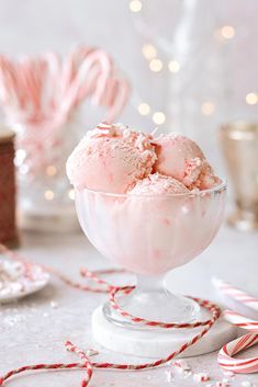 a bowl filled with ice cream next to candy canes