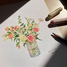 a watercolor painting of flowers in a vase on paper with crayons next to it