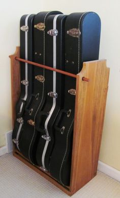 three suitcases stacked on top of each other in a storage rack with doors open