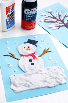 snowman made out of foam and glue sitting on top of a table