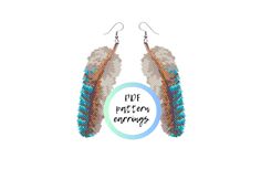 a pair of earrings with feathers hanging from it