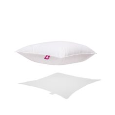 a white pillow sitting on top of a table