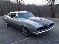 a gray muscle car parked in a parking lot