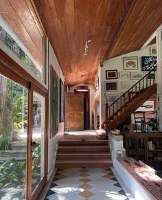 the inside of a house with stairs leading up to it and pictures on the wall