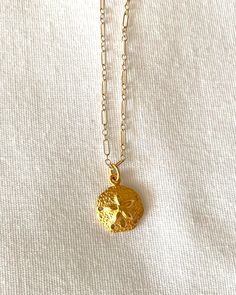 Golden Sand Dollar Necklace - 24 kt Gold plated over bronze sand dollar - Gold plated lobster claw clasp - Gold filled fancy chain Beautiful golden reminder of your beach vacation!  Some view sand dollars as having spiritual meaning. Your unique piece is designed and created by hand in my Tucson studio * Custom orders welcome!  Please contact me through Etsy Gold Charms Jewelry For Vacation, Vacation Gold Jewelry With Charms, Gold Vacation Jewelry With Charms, Gold Necklace With Starfish Charm For Beach Season, Gold Starfish Charm Necklace For Beach Season, Gold Charm Necklaces For Vacation, Gold Charm Necklace For Vacation, Yellow Gold Pendant Necklace For Beach, Ocean-inspired Round Gold Necklace